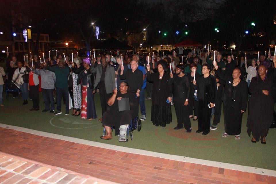 Those attending a Rosewood Massacre centennial event sponsored by The Real Rosewood Foundation hold candles in remembrance of the massacre. The event was held Saturday at the Bo Diddley Downtown Community Plaza in Gainesville.
(Photo: Photo by Voleer Thomas/For The Guardian)
