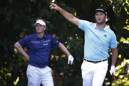 Jun 25, 2016; Bethesda, MD, USA; Jon Rahm of Spain reacts after hitting his tee shot on the sixth hole as Billy Hurley III of the United States (L) looks on during the third round of the Quicken Loans National golf tournament at Congressional Country Club - Blue Course. Mandatory Credit: Geoff Burke-USA TODAY Sports