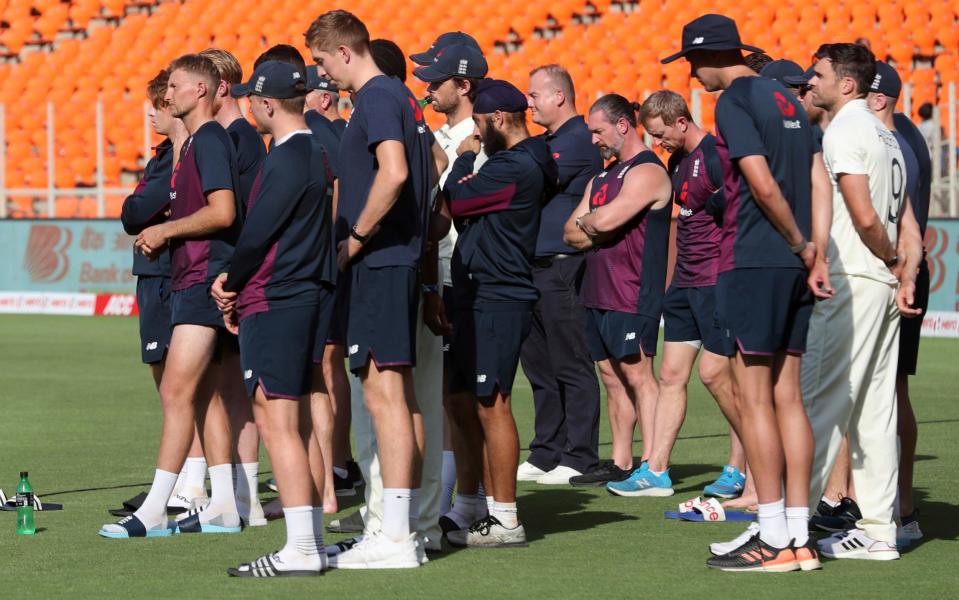 England's players watch on as India are presented with the trophy - AP