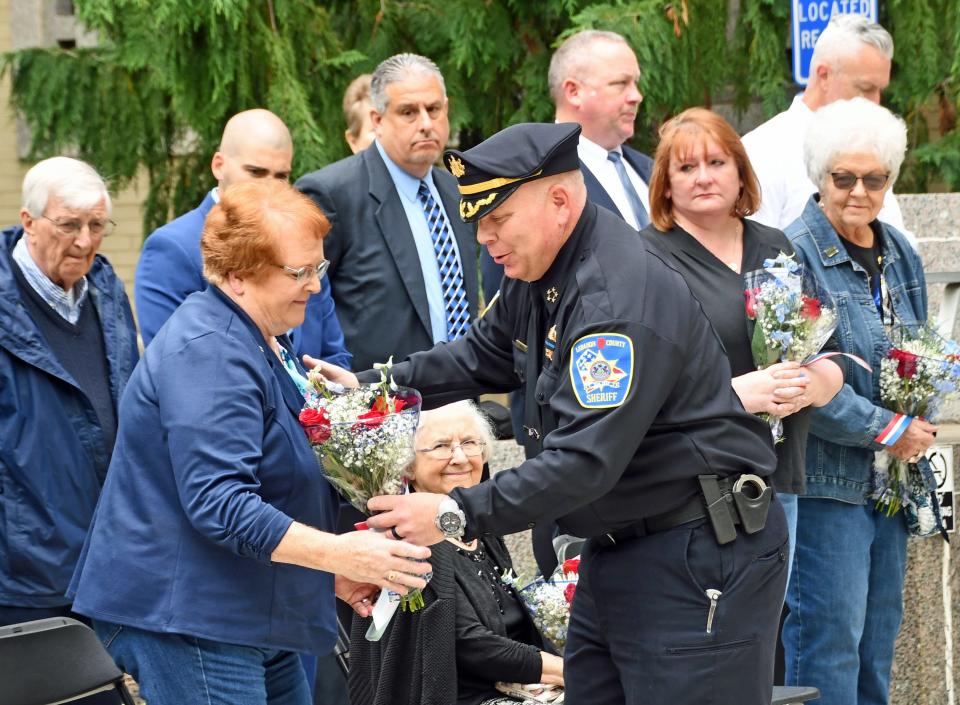 Lebanon County Sheriff Jeffrie Marley gives flowers to Karen Dugan Tuesday to recognize her husband's service in the Annville Township Police Department. Former Police Chief Bernard Dugan passed away in October 2023 after fighting a short battle with cancer.