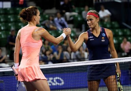 Tennis - Pan Pacific Open Women's Singles Quarterfinal match - Ariake Coliseum, Tokyo, Japan - 23/09/16. Monica Puig (R) of Puerto Rico shakes hands with Agnieszka Radwanska of Poland after their match. REUTERS/Kim Kyung-Hoon