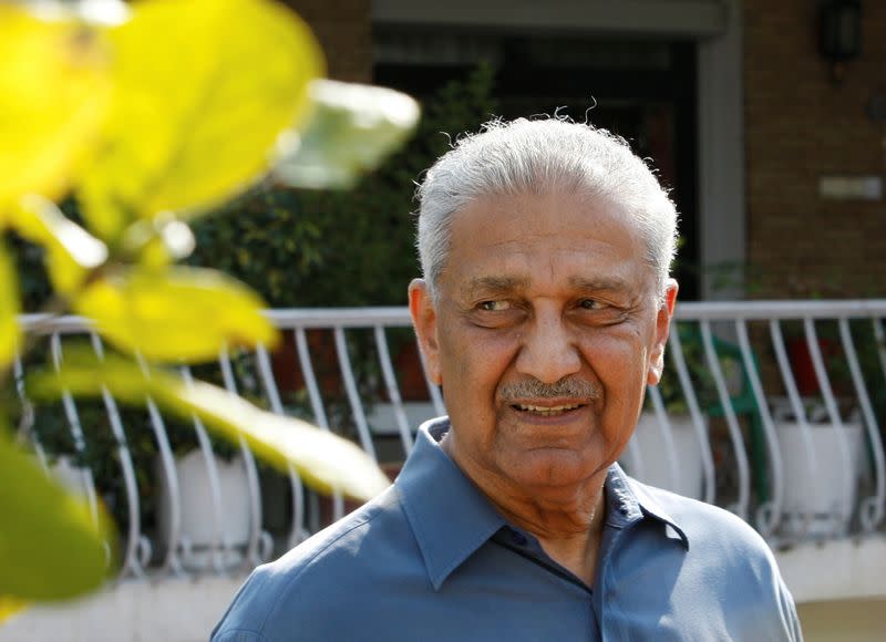 FILE PHOTO: Nuclear scientist Khan smiles at media after his court verdict outside his residence in Islamabad