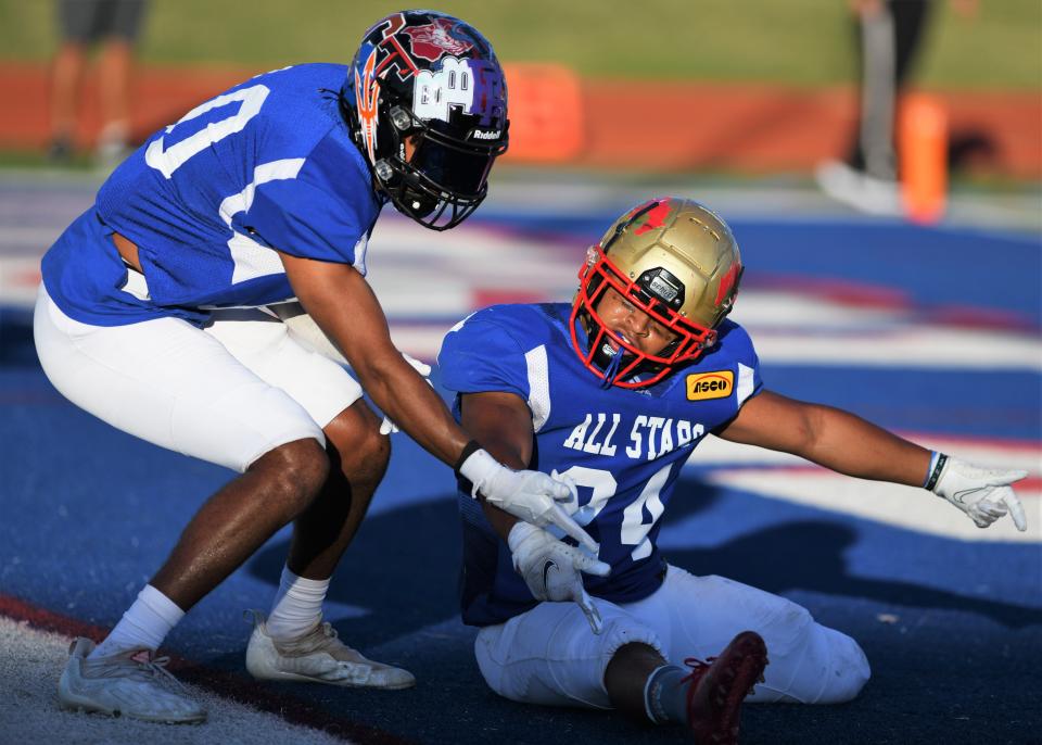 Tascosa's Michael Ayalew, left, helps celebrate a touchdown by Coronado's Antonio Malone in the ASCO All-Star Classic football game Saturday, June 4, 2022, at Lowrey Field in Lubbock.