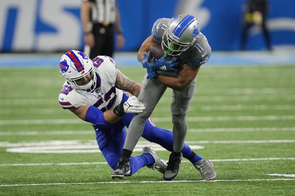 Buffalo Bills linebacker A.J. Klein (52) tackles Detroit Lions wide receiver Kalif Raymond (11) during the second half of an NFL football game, Thursday, Nov. 24, 2022, in Detroit. (AP Photo/Paul Sancya)