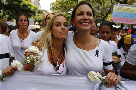 Opposition deputy Maria Corina Machado (R) and Lilian Tintori, wife of jailed opposition leader Leopoldo Lopez, take part in a women's rally against Nicolas Maduro's government in Caracas February 26, 2014. REUTERS/Jorge Silva