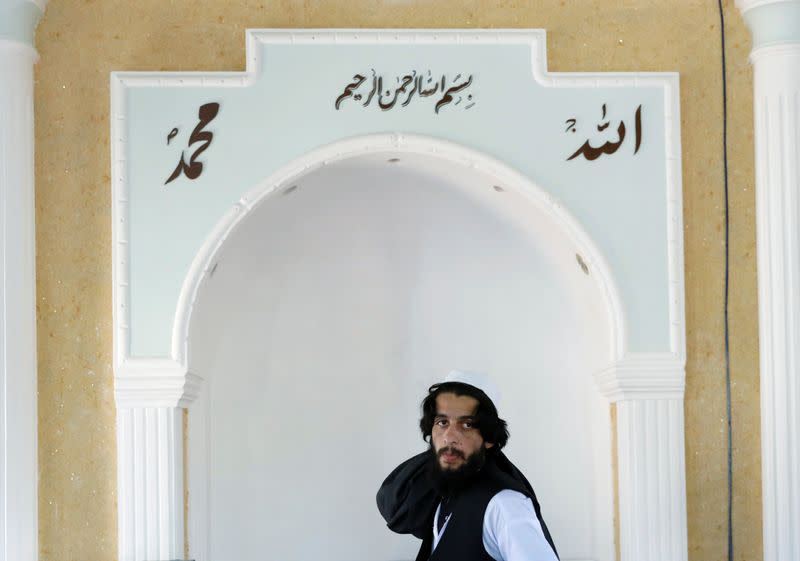 A newly freed Taliban prisoner looks on as he changes his clothes in Pul-i-Charkhi prison, in Kabul, Afghanistan