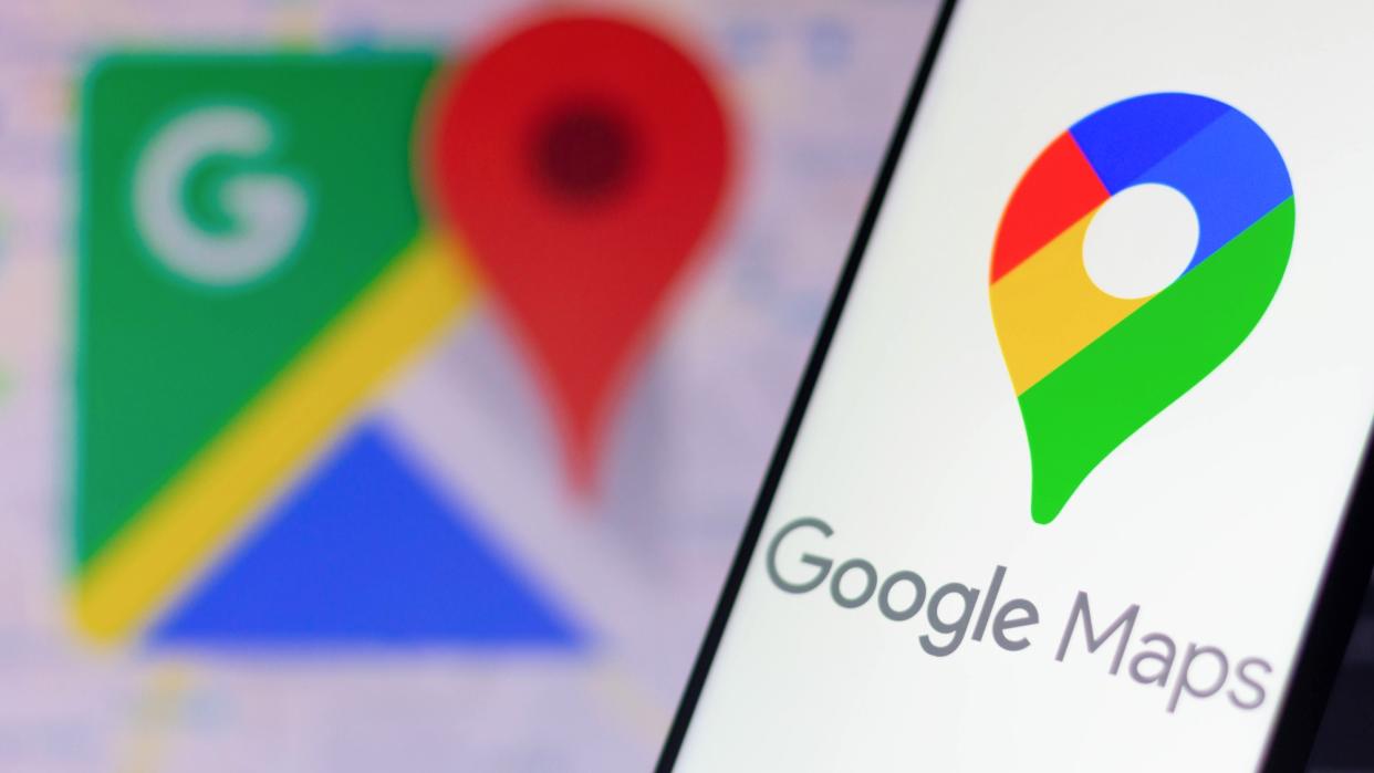  Google Maps logo on smartphone with Google Maps logo in background. 