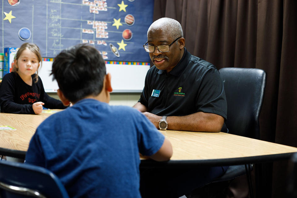 Mark Harmon, right, is with Pando Initiative, a nonprofit organization that helps school districts address chronic absenteeism and maintain connections with students who could be at risk for dropping out. Federal relief funds are paying for the program in the Wichita Public Schools. (Wichita Public Schools)