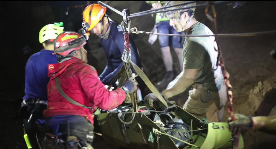 Rescue workers stretcher one of the boys through the cave. Source: Facebook/Thai Navy SEALS