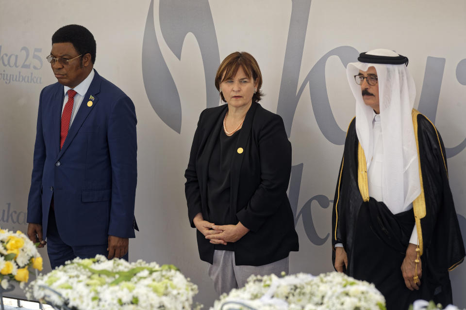 President of the Swiss National Council Marina Carobbio Guscetti, center, prepares to lay a wreath at the Kigali Genocide Memorial in Kigali, Rwanda Sunday, April 7, 2019. Rwanda is commemorating the 25th anniversary of when the country descended into an orgy of violence in which some 800,000 Tutsis and moderate Hutus were massacred by the majority Hutu population over a 100-day period in what was the worst genocide in recent history. (AP Photo/Ben Curtis)