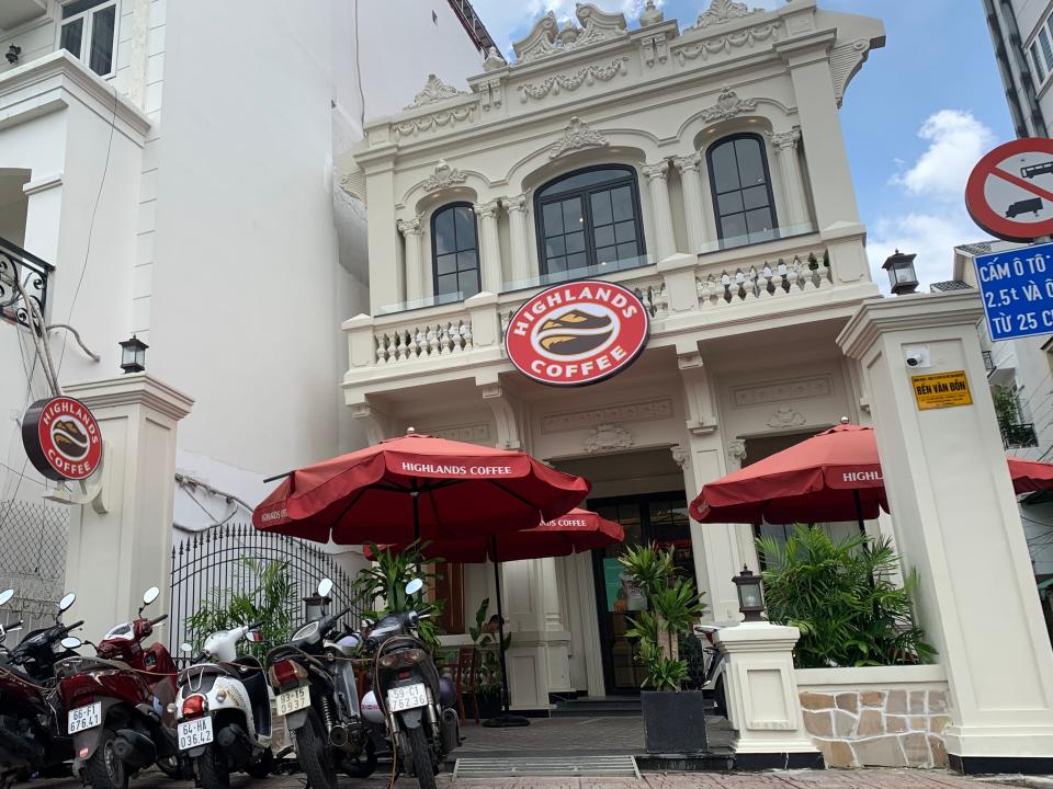 Building in Ho Chi Minh that houses a coffeeshop with motorcycles parked out front.