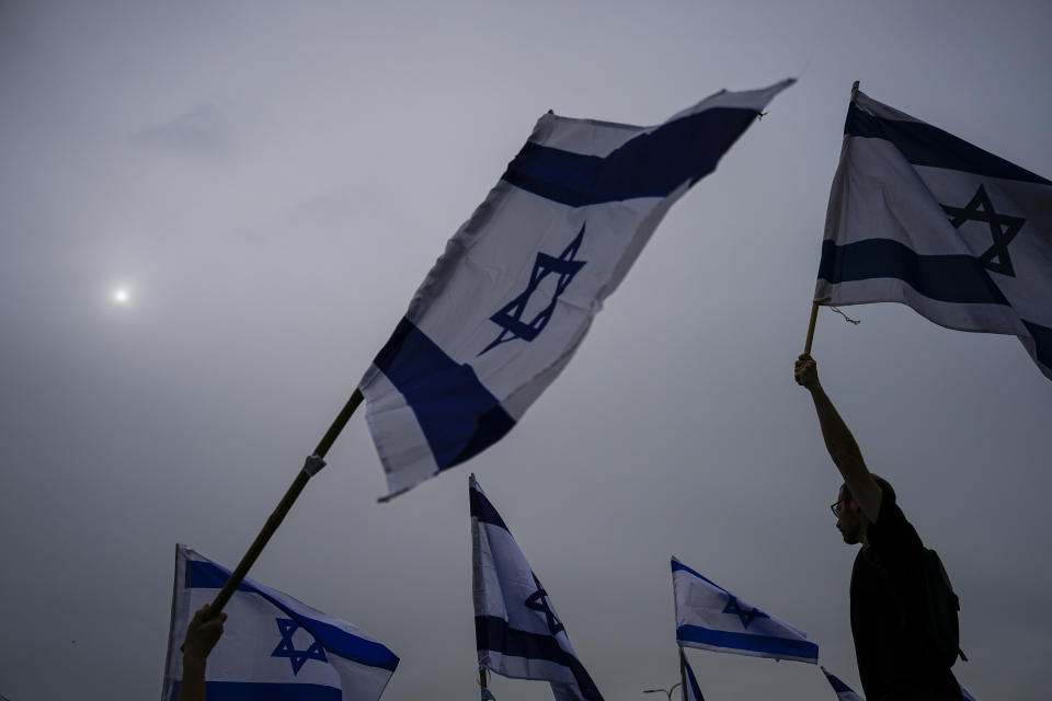 Israelis protest against plans by Prime Minister Benjamin Netanyahu's government to overhaul the judicial system in Beit Beit Yanai interchange, Israel as they block the free way Thursday, March 23, 2023. (AP Photo/Ariel Schalit)