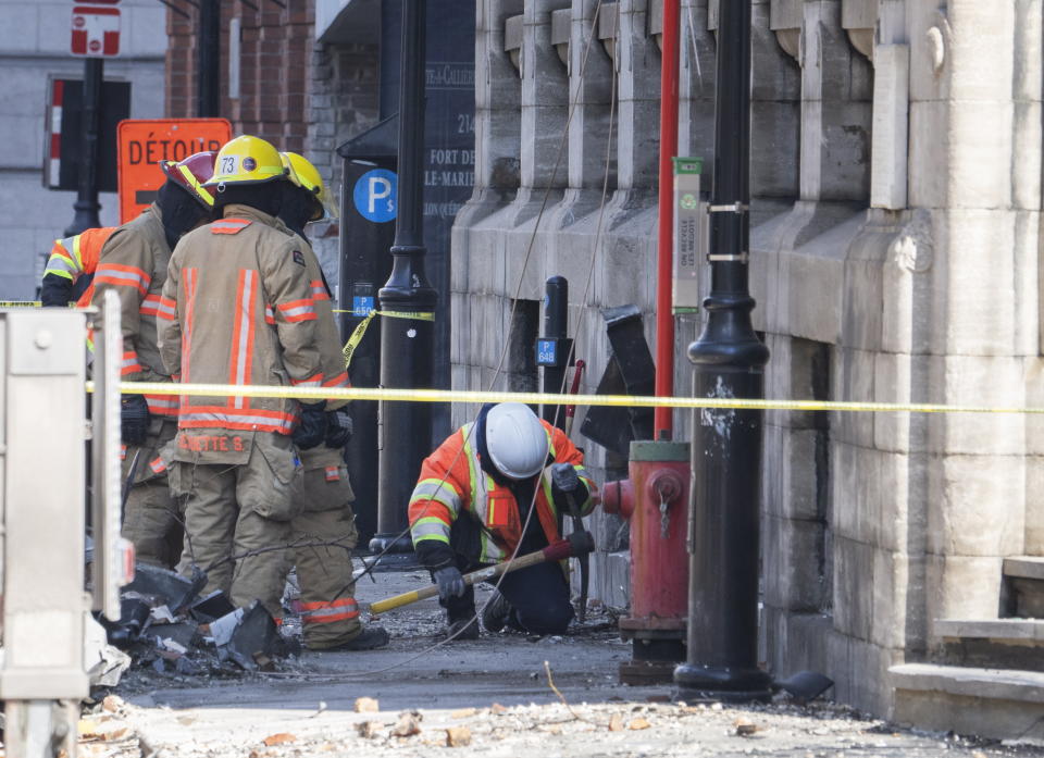 Firefighters continue the search for victims Monday, March 20, 2023 at the scene of last week's fire in Montreal. Montreal’s mayor is vowing to better regulate Airbnb in her city as the search continues for six people missing through a building that included Airbnb units in a historic city section where they are banned. (Ryan Remiorz/The Canadian Press via AP)