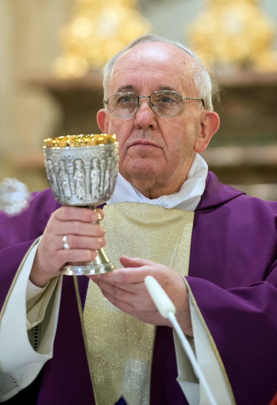 In this photo provided by the Vatican paper L'Osservatore Romano, Pope Francis celebrates Mass at the Vatican St. Anna parish church, Sunday, March 17, 2013. Pope Francis began his first Sunday as pontiff by making an impromptu appearance to the public from a side gate of the Vatican, startling passersby and prompting cheers, then kept up his simple, spontaneous style by delivering a brief, off-the-cuff homily at the Vatican's tiny parish church. Dressed only in white cassock, Francis waved to the crowd in the street outside St. Anna's Gate and before entering the church, which serves Vatican City State's hundreds of residents, he shook hands of the parishioners and kissed babies. (AP Photo/L'Osservatore Romano)