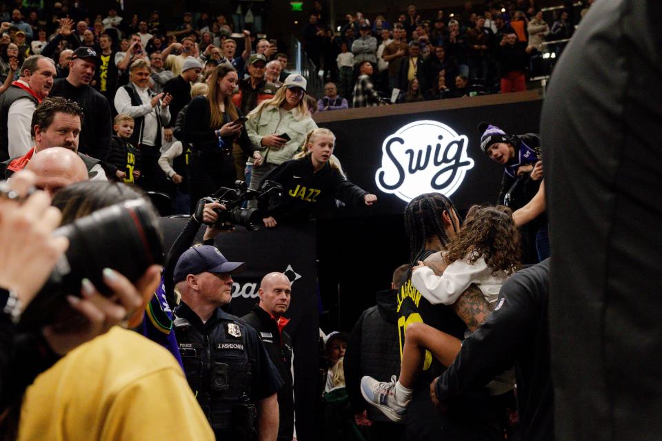 Utah Jazz guard Jordan Clarkson (00) holds his daughter Callie Clarkson while fans cheer him on after the NBA basketball game between the Utah Jazz and the Dallas Mavericks where Clarkson got a triple double and the Jazz won 127-90 at the Delta Center in Salt Lake City on Monday, Jan. 1, 2024. | Megan Nielsen, Deseret News