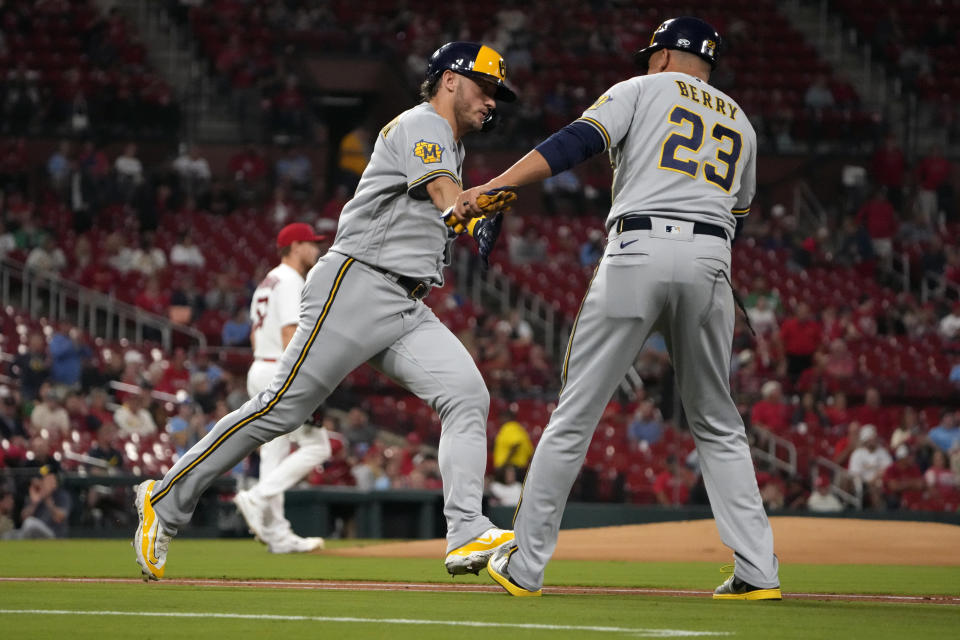 Milwaukee Brewers' Josh Donaldson is congratulated by first base coach Quintin Berry (23) after hitting a three-run home run off St. Louis Cardinals starting pitcher Zack Thompson, left, during the first inning of a baseball game Wednesday, Sept. 20, 2023, in St. Louis. (AP Photo/Jeff Roberson)