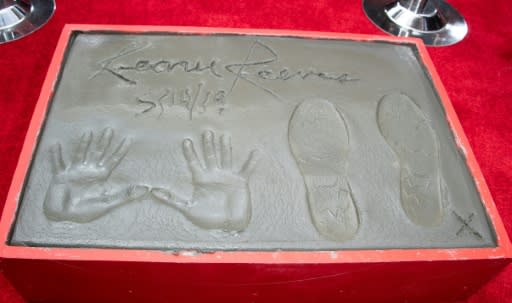 Reeves's handprints, footprints and signature are seen during a ceremony in his honor at the TCL Chinese Theatre IMAX forecourt