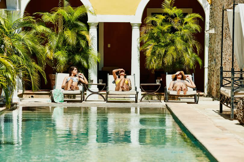 Three women on sun loungers