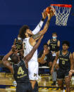 Michigan forward Isaiah Livers (2) goes to the basket while defended by Oakland forward Daniel Oladapo (4) in the first half of an NCAA college basketball game at Crisler Center in Ann Arbor, Mich., Sunday, Nov. 29, 2020. (AP Photo/Tony Ding)