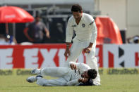 Sachin Tendulkar of India tends to Virat Kholi of India after he was injured during day three of the first Star Sports test match between India and The West Indies held at The Eden Gardens Stadium in Kolkata, India on the 8th November 2013 Photo by: Ron Gaunt - BCCI - SPORTZPICS