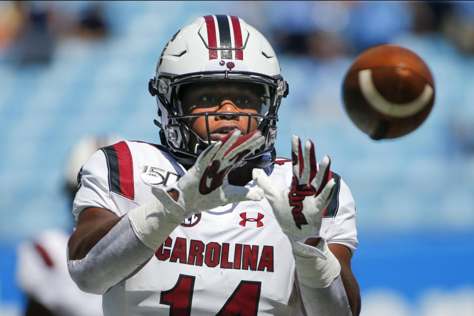 FILE - In this Aug. 31, 2019, file photo, South Carolina running back Deshaun Fenwick warms up prior to an NCAA college football game against North Carolina in Charlotte, N.C. For the college athletes who are heading into a season of uncertainty brought on by COVID-19, the NCAA's decision to not charge them a year of eligibility, no matter how much they play, brings peace of mind. (AP Photo/Nell Redmond, File)