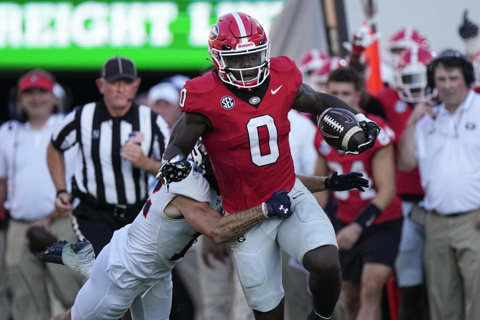 Georgia running back Roderick Robinson II (0) is tackled by Tennessee-Martin safety Carson Evans (12) during the first half of an NCAA college football game Saturday, Sept. 2, 2023, in Athens, Ga. (AP Photo/John Bazemore)