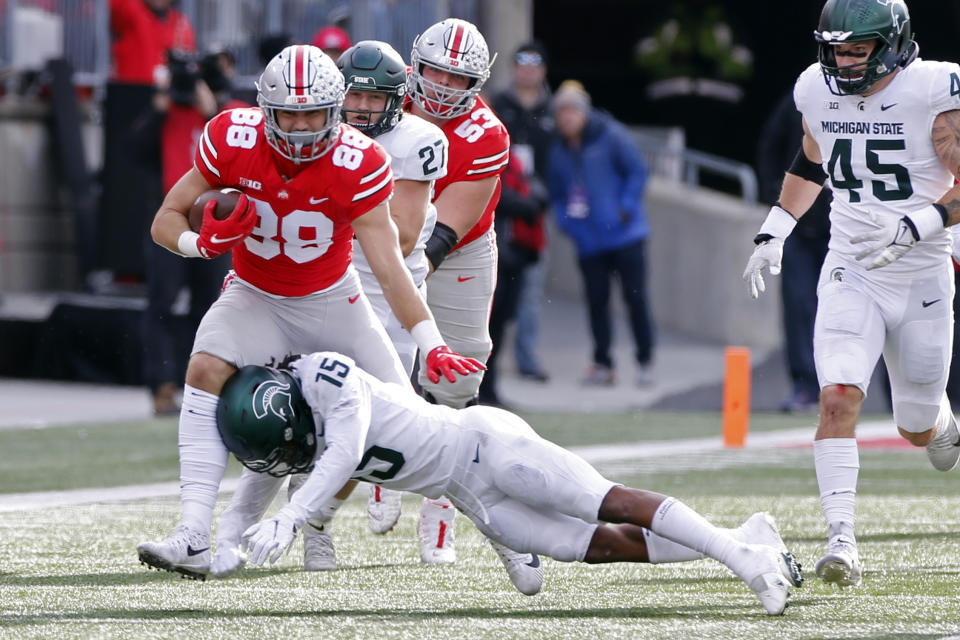 Ohio State tight end Jeremy Ruckert, left, tries to run past Michigan State defensive back Angelo Grose during the first half of an NCAA college football game Saturday, Nov. 20, 2021, in Columbus, Ohio. (AP Photo/Jay LaPrete)