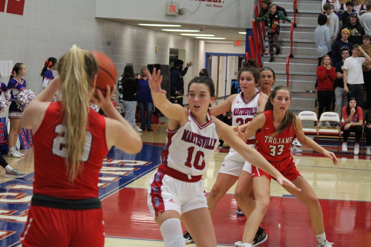 Martinsville junior Maci Dorsett (10) and senior Haley Polston (30) are in zone defense during Tuesday's home game against Center Grove.