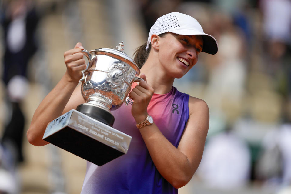 Poland's Iga Swiatek holds the trophy after winning the women's final of the French Open tennis tournament against Italy's Jasmine Paolini at the Roland Garros stadium in Paris, France, Saturday, June 8, 2024. (AP Photo/Thibault Camus)