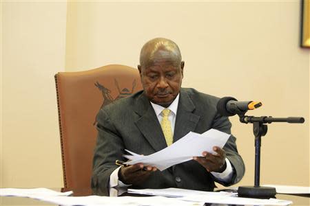 Uganda President Yoweri Museveni signs an anti-homosexual bill into law at the state house in Entebbe, 36 km (22 miles) south west of capital Kampala February 24, 2014. REUTERS/James Akena