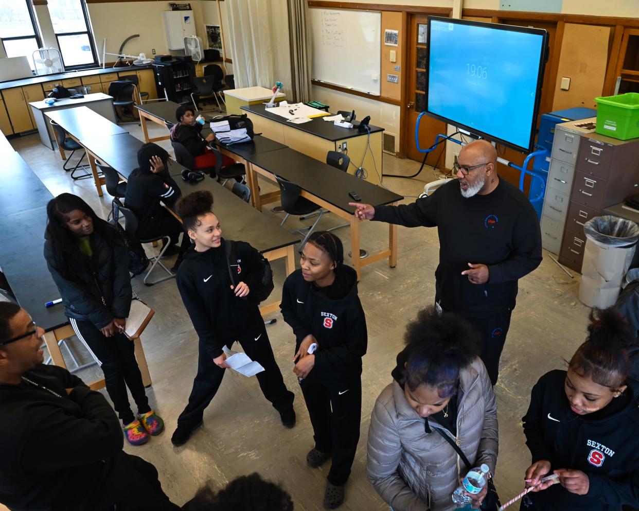 United Mentoring Program Director Karry Smith (top right), and founder and director Tracy Edmond, left, chat with Sexton High School students, Thursday, Dec. 21, 2023, before their after-school mentoring session with students.