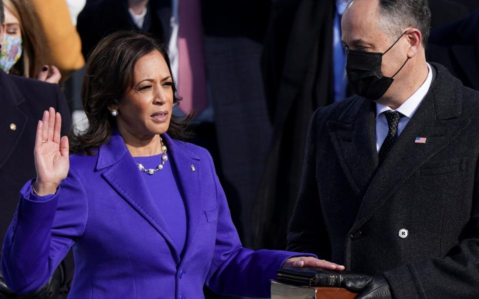 Kamala Harris is sworn in as U.S. Vice President as her spouse Doug Emhoff holds a bible during the inauguration of Joe Biden as the 46th President of the United States on the West Front of the U.S. Capitol in Washington, U.S., January 20, 2021. - REUTERS