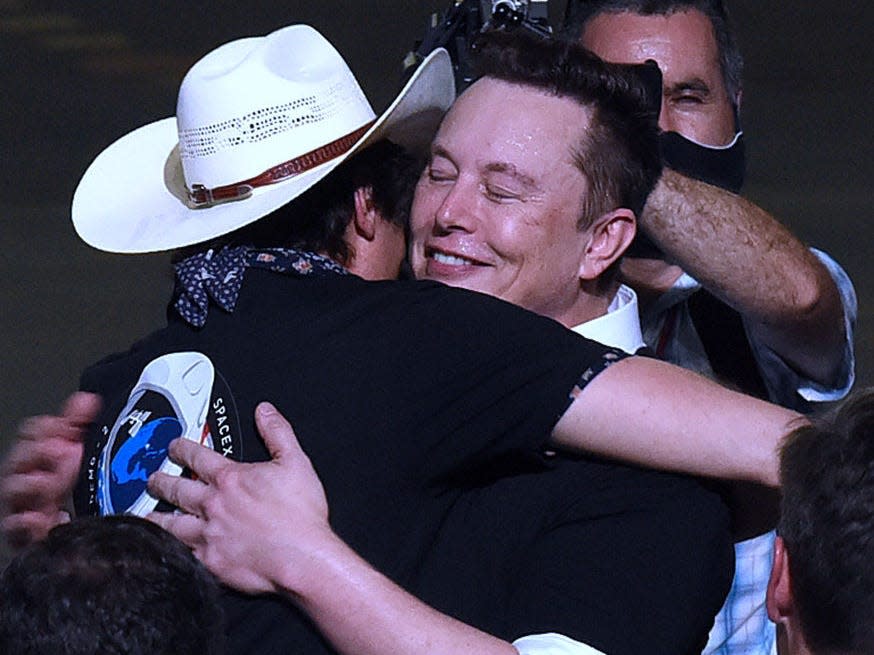 SpaceX founder Elon Musk embraces his brother, Kimbal Musk, after being recognized by U.S. Vice President Mike Pence at NASA's Vehicle Assembly Building following the successful launch of a Falcon 9 rocket with the Crew Dragon spacecraft from pad 39A at the Kennedy Space Center on May 20, 2020.