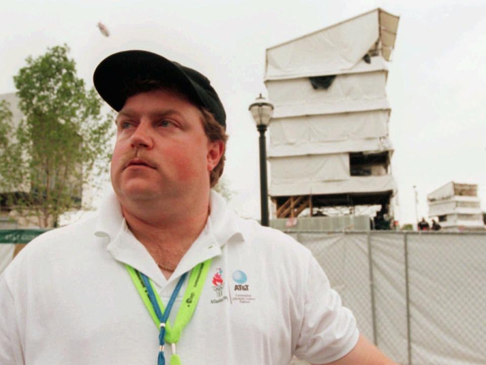 The day after the attack, the real Richard Jewell was photographed across from the tower where he found a bomb and warned visitors at Centennial Olympic Park in Atlanta.