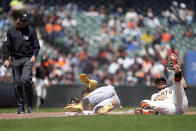 Pittsburgh Pirates' Rodolfo Castro, center, is tagged out trying to steal third base by San Francisco Giants third baseman J.D. Davis (7) during the fifth inning of a baseball game in San Francisco, Wednesday, May 31, 2023. (AP Photo/Tony Avelar)