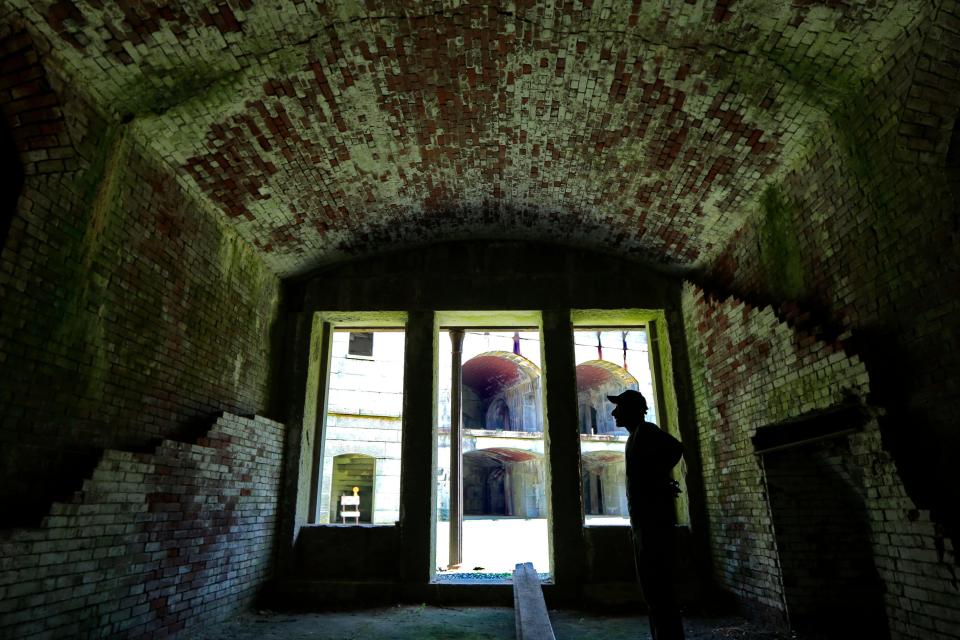 Richard Landry, worker with New Bedford Parks department, takes a look around the inside of Fort Rodman located at Fort Taber Park in the south end of New Bedford after he cut the lawn in the inner yard of the civil war fort.