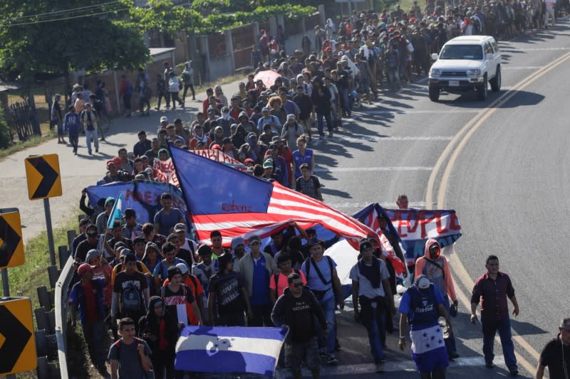 Migrants, mainly from Central America and marching in a caravan, walk on a road near Ignacio Zaragoza, Chiapas