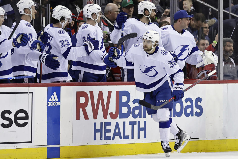 Tampa Bay Lightning left wing Brandon Hagel (38) celebrates with teammates after scoring a goal against the New Jersey Devils during the second period of an NHL hockey game Tuesday, March 14, 2023, in Newark, N.J. (AP Photo/Adam Hunger)
