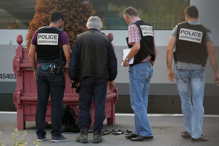 French judicial police stand on the train platform near gun cartridges and a backpack in Arras, France, August 21, 2015. REUTERS/Pascal Rossignol