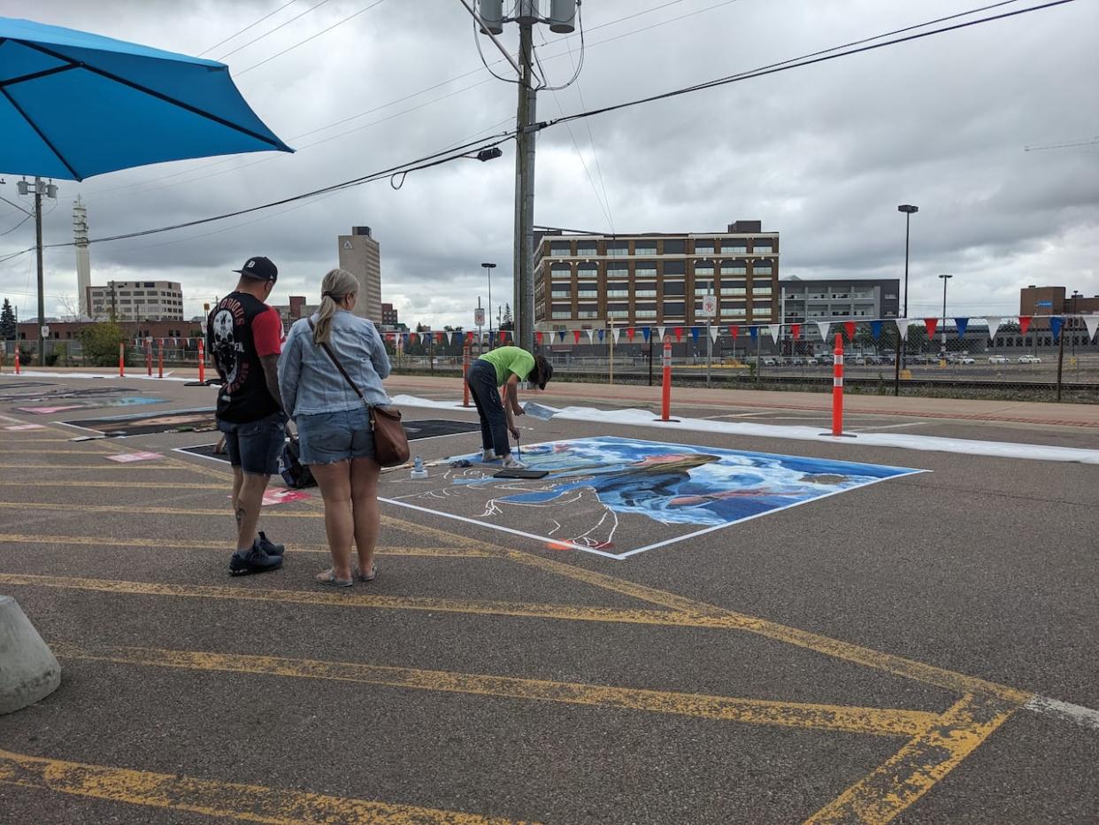 Members of the public are able to watch the artists work and interact them while they work, which several of the artists said they enjoy. (Vanessa Moreau/CBC - image credit)