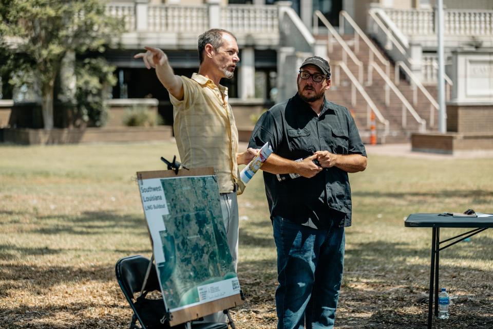 Justin Kray, left, and James Hiatt with the Louisiana Bucket Brigade talk on May 17, 2022, about the effects of Liquid Natural Gas plants on southwest Louisiana.