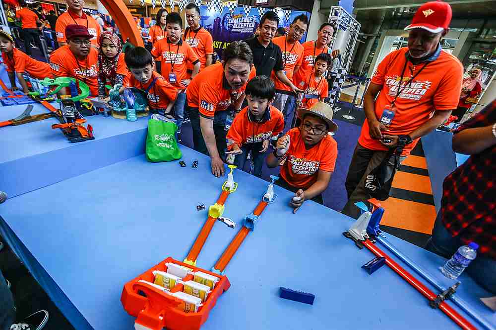 Children watch on as their cars fly through one of the obstacle courses at the Hot Wheels Challenge Accepted Championship 2019 National Finals at IOI Mall Putrajaya. — Picture courtesy of Hot Wheels Malaysia