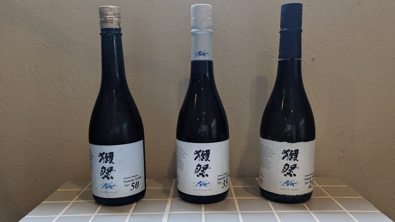 three bottles of sake on counter