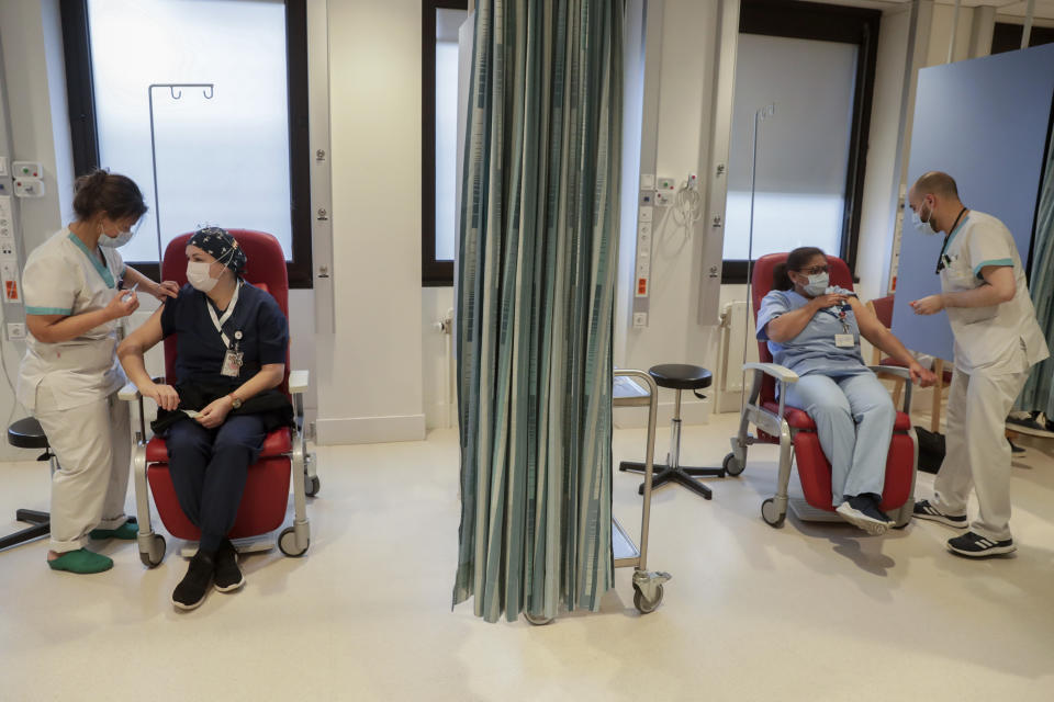 Nurses administer Moderna COVID-19 vaccines to health care workers during the national launch of the vaccination of hospital staff at the Etterbeek-Ixelles site of the Iris Sud Hospitals in Brussel​s, Monday, Jan. 18, 2021. (Stephanie Lecocq, Pool Photo via AP)