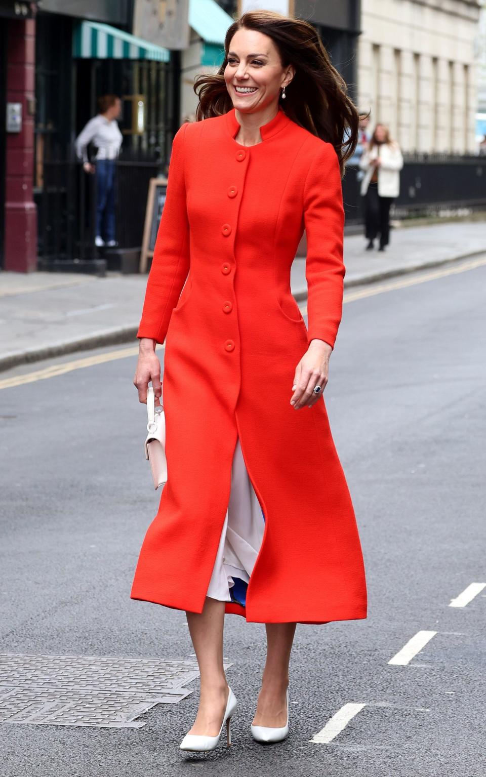 Wearing a red Eponine coat while visiting the Dog & Duck Pub in Soho ahead of the coronation