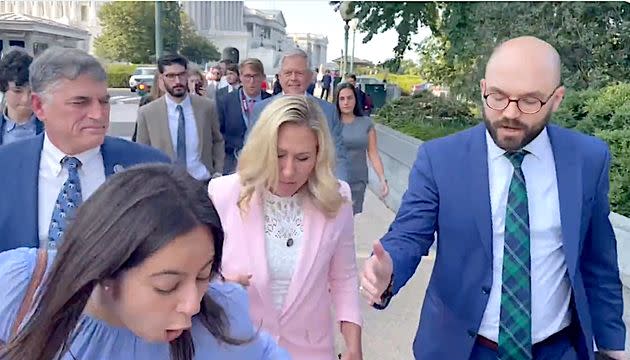 Marianna Pecora stumbles after she said Marjorie Taylor Greene kicked her. (Photo: Screen Shot/Twitter/Marjorie Taylor Greene)