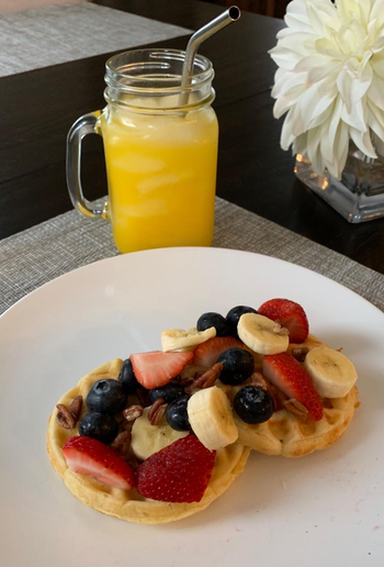 reviewer pic of two waffles made using the maker with fruit on top