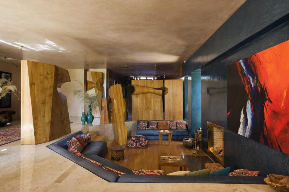 Interior of a room with unique wooden structures and a red artwork on the wall