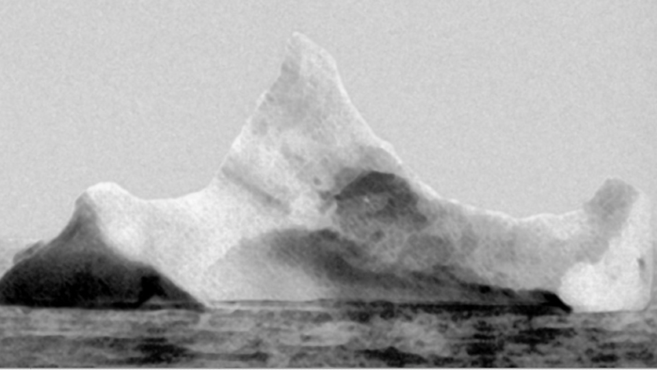 This iceberg  may have gouged a 300-foot tear in the hull. A photographer from another vessel noticed a long red paint stripe on the iceberg a day after the sinking. - Credit: Courtesy Wikimedia Public