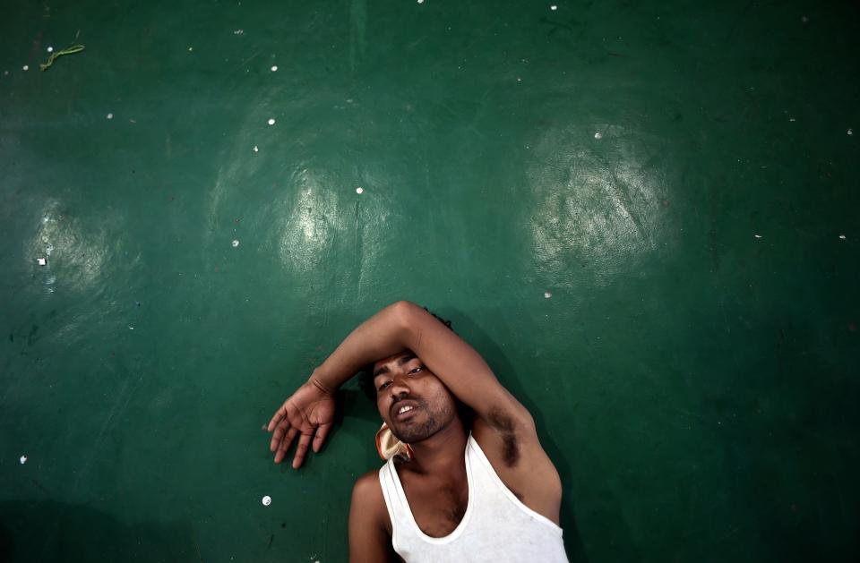 Bangladeshi migrant Ramzaan rests on the floor at the Police headquarters in Langkawi on May 11, 2015, after landing up on the Malaysian shores earlier in the day.  (MANAN VATSYAYANA/AFP/Getty Images)